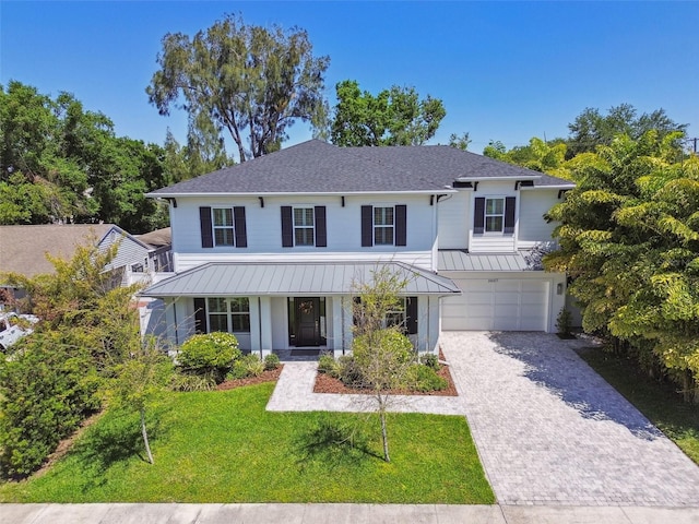3607 W Roland St, Tampa, FL 33609 - modern farmhouse style home with a porch, a front lawn, a garage, metal roof, and decorative driveway