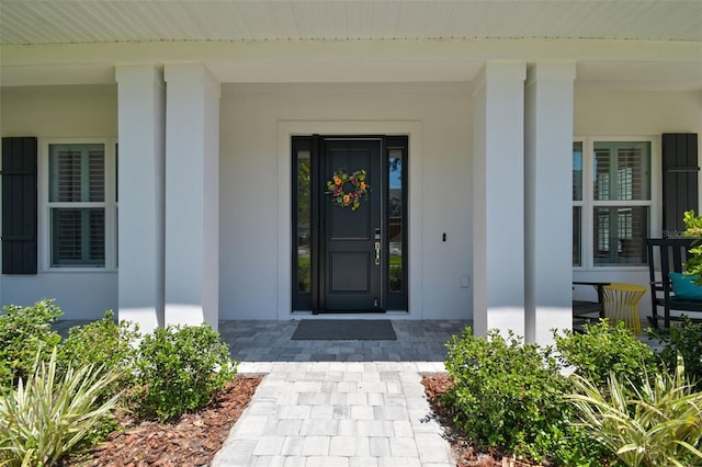 3607 W Roland St, Tampa, FL 33609 - property entrance featuring covered porch and stucco siding