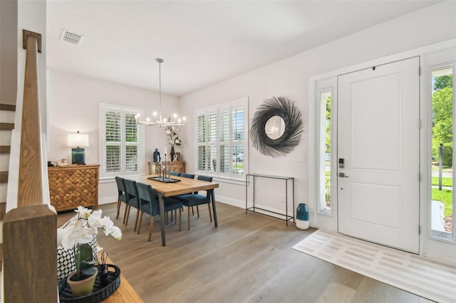3607 W Roland St, Tampa, FL 33609 - interior space with visible vents, a wealth of natural light, wood finished floors, and a chandelier