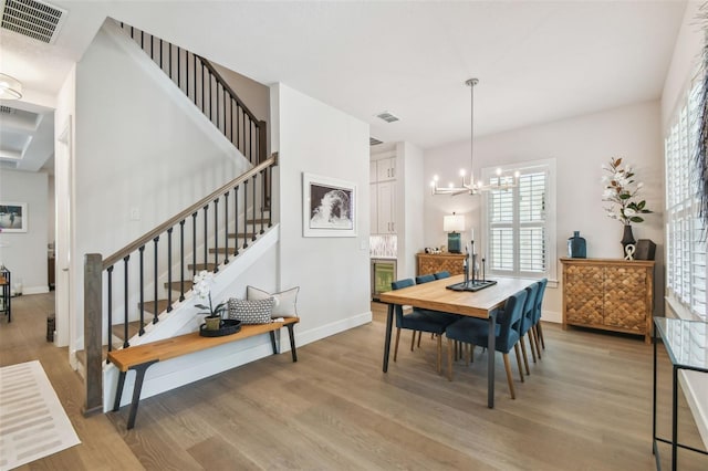 3607 W Roland St, Tampa, FL 33609 - dining room with stairway, visible vents, and wood finished floors