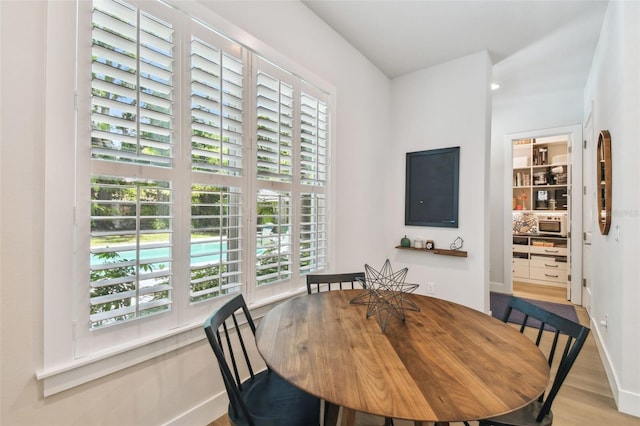 3607 W Roland St, Tampa, FL 33609 - dining area featuring baseboards, wood finished floors, and a healthy amount of sunlight