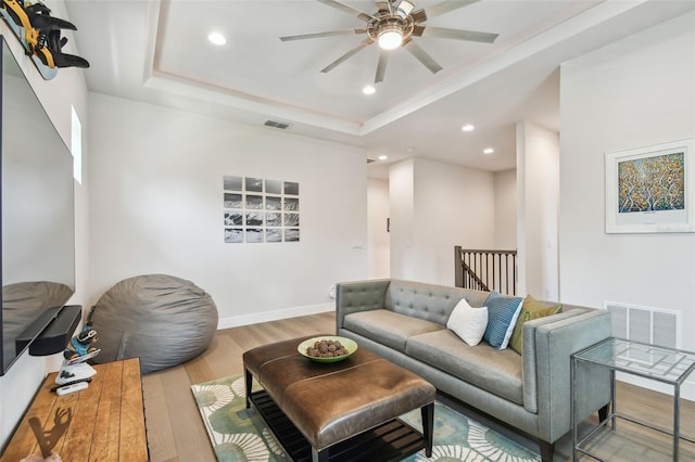 3607 W Roland St, Tampa, FL 33609 - living area with visible vents, ceiling fan, wood finished floors, and a tray ceiling