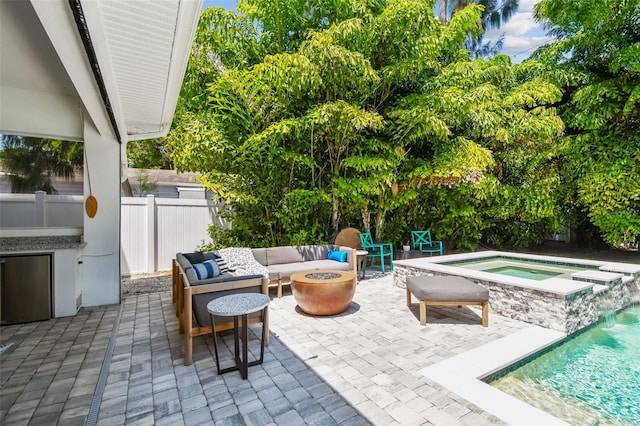 3607 W Roland St, Tampa, FL 33609 - view of patio featuring fence, an outdoor living space with a fire pit, an in ground hot tub, and a fenced in pool
