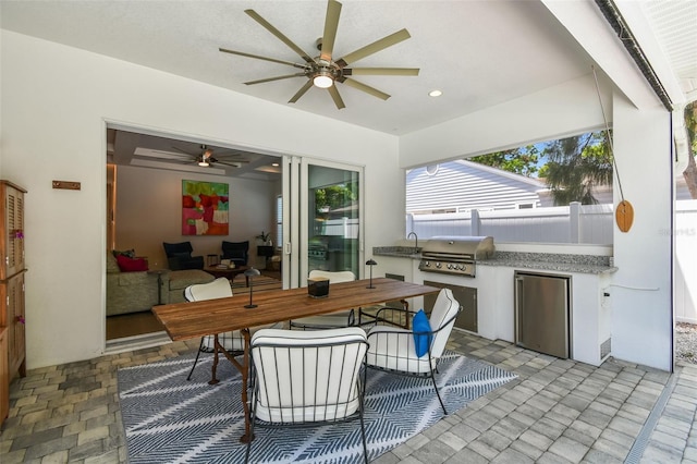 3607 W Roland St, Tampa, FL 33609 - view of patio / terrace featuring outdoor dining area, ceiling fan, area for grilling, an outdoor kitchen, and fence