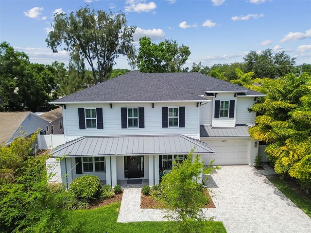 3607 W Roland St, Tampa, FL 33609 - view of front of property featuring metal roof, driveway, and a shingled roof
