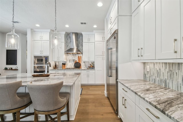 3607 W Roland St, Tampa, FL 33609 - kitchen featuring built in appliances, visible vents, recessed lighting, and wall chimney exhaust hood