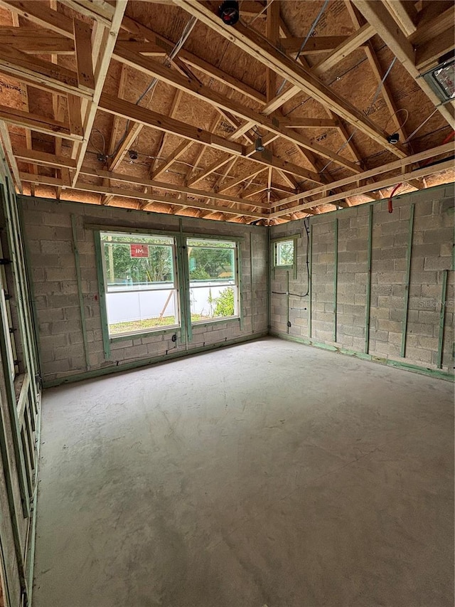 misc room featuring a healthy amount of sunlight and unfinished concrete floors