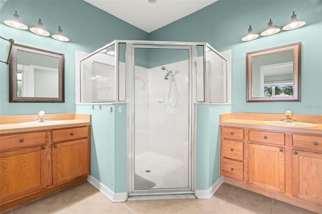 19232 Barred Owl Ct, Land O Lakes, FL 34638 - bathroom featuring a shower stall, two vanities, and tile patterned floors