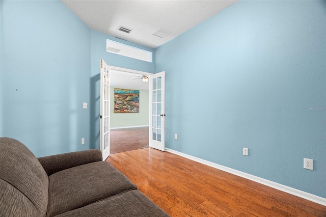 19232 Barred Owl Ct, Land O Lakes, FL 34638 - sitting room with french doors, wood finished floors, and a ceiling fan