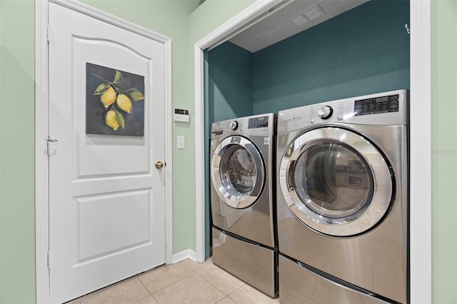19232 Barred Owl Ct, Land O Lakes, FL 34638 - washroom featuring light tile patterned flooring and independent washer and dryer