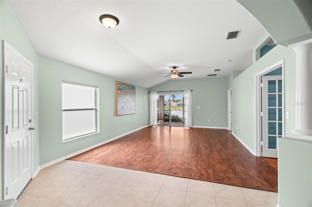 19232 Barred Owl Ct, Land O Lakes, FL 34638 - tiled empty room featuring vaulted ceiling, ceiling fan, and decorative columns