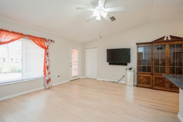 unfurnished living room featuring ceiling fan, visible vents, light wood-type flooring, and lofted ceiling