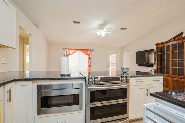 kitchen featuring built in microwave, double oven range, a ceiling fan, and white cabinetry