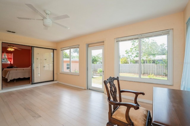 office with visible vents, ceiling fan, light wood-style floors, and baseboards