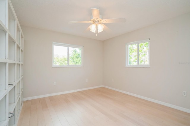 empty room with light wood-style flooring, ceiling fan, and baseboards
