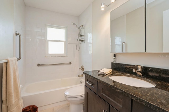 bathroom with toilet, vanity, tile patterned flooring, and  shower combination