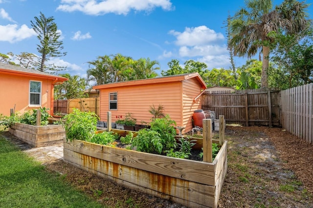 view of yard with a fenced backyard and a vegetable garden