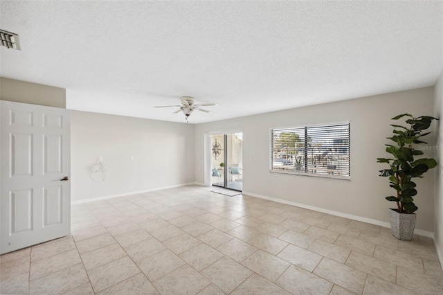 2387 Hanover Dr Unit 2387, Dunedin, FL 34698 - unfurnished room with ceiling fan, light tile patterned flooring, baseboards, and a textured ceiling