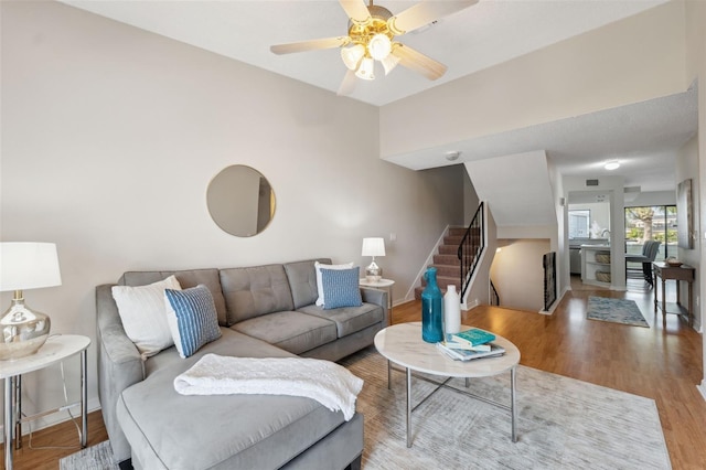 2387 Hanover Dr Unit 2387, Dunedin, FL 34698 - living room featuring baseboards, stairway, wood finished floors, and ceiling fan