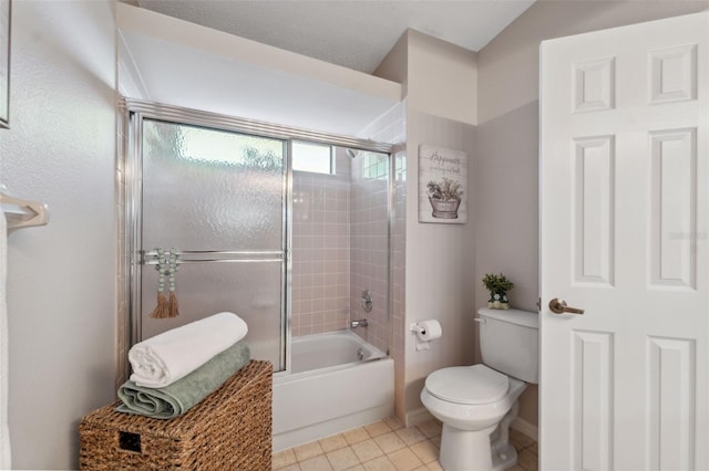 2387 Hanover Dr Unit 2387, Dunedin, FL 34698 - bathroom featuring toilet, tile patterned flooring, shower / bath combination with glass door, and baseboards