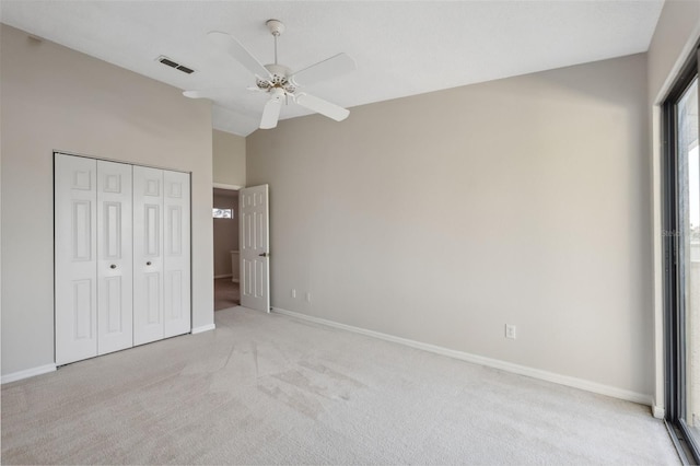 2387 Hanover Dr Unit 2387, Dunedin, FL 34698 - unfurnished bedroom featuring light carpet, baseboards, a closet, and a ceiling fan