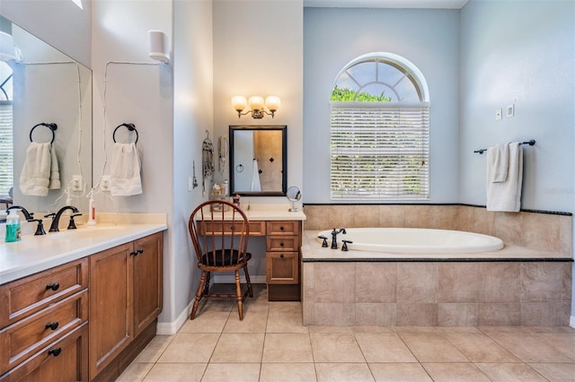 full bath with a garden tub, vanity, and tile patterned flooring
