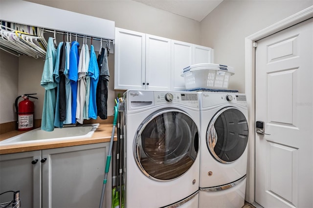 laundry room with washing machine and dryer and cabinet space