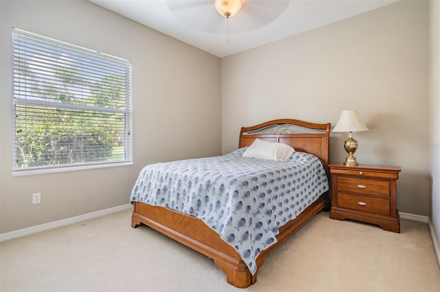 carpeted bedroom featuring baseboards and a ceiling fan