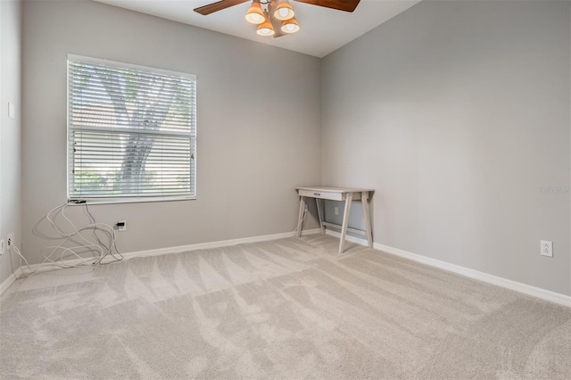 empty room with carpet floors, baseboards, and ceiling fan