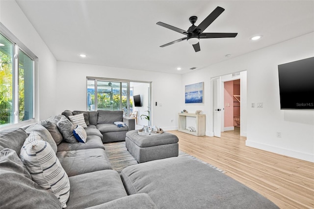 living area featuring light wood-style floors, recessed lighting, and a wealth of natural light