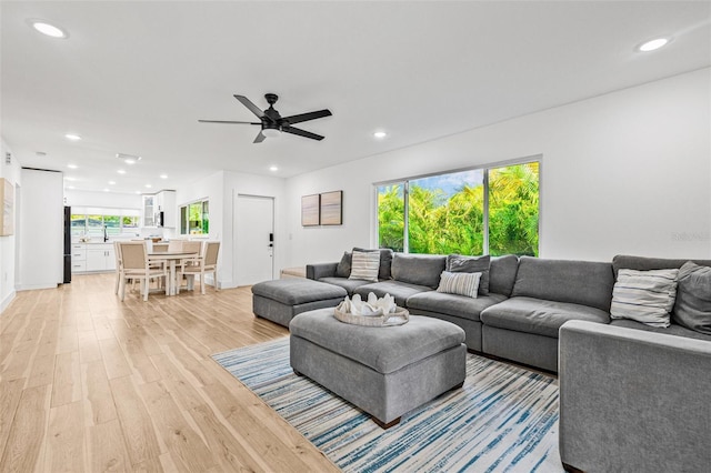 living area with recessed lighting, light wood finished floors, and ceiling fan