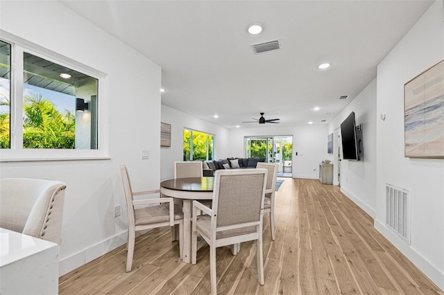 dining area featuring visible vents, baseboards, and light wood finished floors