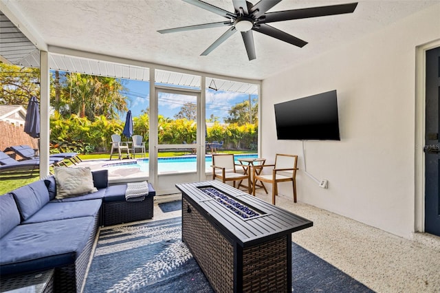 exterior space featuring a wall of windows, a textured ceiling, a ceiling fan, and speckled floor