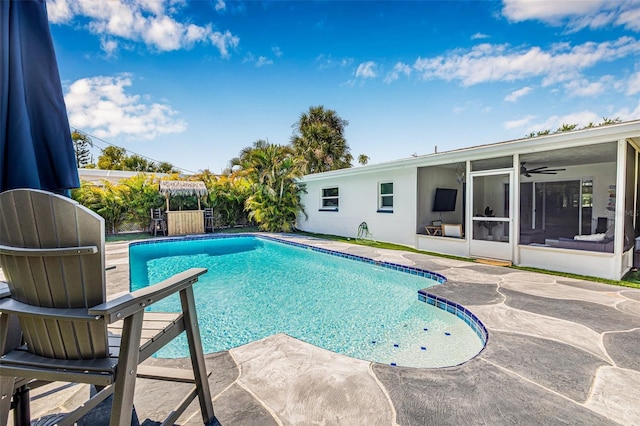 pool with a patio area and a sunroom