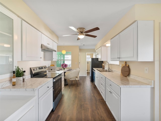 kitchen with ceiling fan, white cabinets, under cabinet range hood, a sink, and electric stove