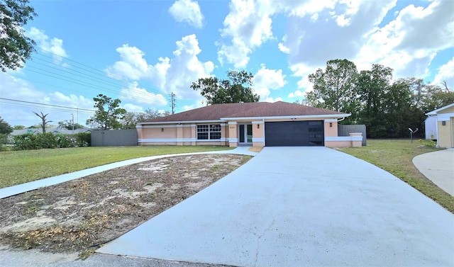 ranch-style house with a garage, fence, concrete driveway, a front lawn, and stucco siding