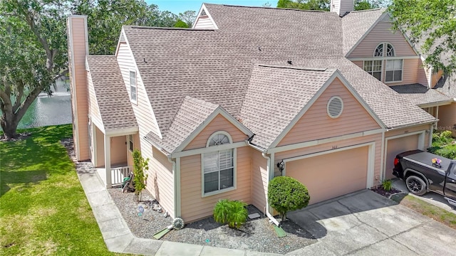 3611 Pine Knot Dr, Valrico, FL 33596 - view of front of property with a front lawn, a chimney, driveway, roof with shingles, and an attached garage