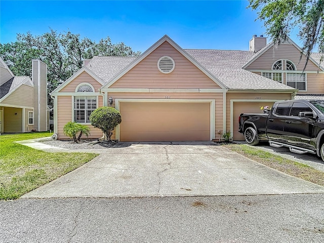 3611 Pine Knot Dr, Valrico, FL 33596 - view of front of home featuring concrete driveway, a shingled roof, and a garage
