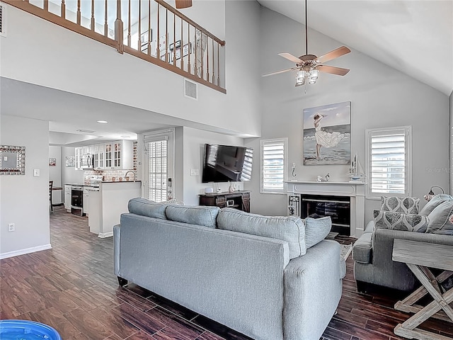 3611 Pine Knot Dr, Valrico, FL 33596 - living area featuring dark wood-style floors, a ceiling fan, high vaulted ceiling, and a wealth of natural light