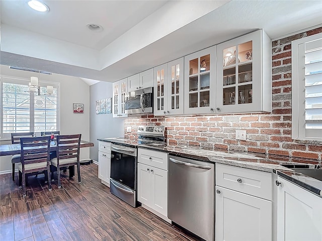 3611 Pine Knot Dr, Valrico, FL 33596 - kitchen with dark wood-style flooring, stainless steel appliances, glass insert cabinets, baseboards, and white cabinets