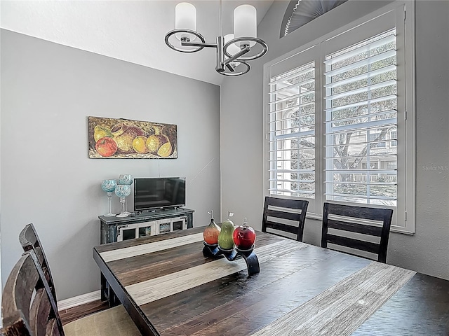 3611 Pine Knot Dr, Valrico, FL 33596 - dining area featuring a chandelier, baseboards, and wood finished floors
