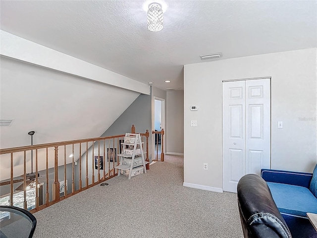 3611 Pine Knot Dr, Valrico, FL 33596 - sitting room featuring lofted ceiling, a textured ceiling, visible vents, baseboards, and carpet