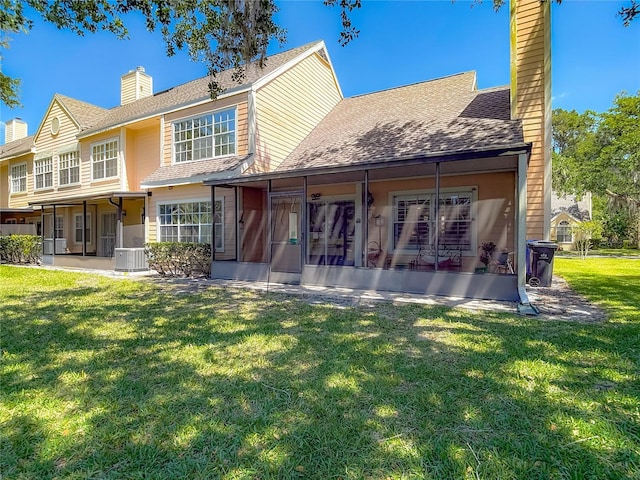3611 Pine Knot Dr, Valrico, FL 33596 - rear view of property featuring a chimney, roof with shingles, a yard, central AC, and a sunroom