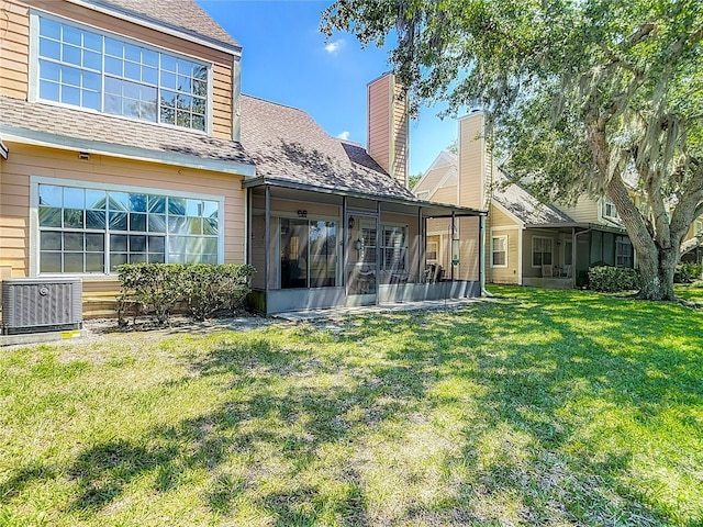 3611 Pine Knot Dr, Valrico, FL 33596 - back of house featuring a sunroom, a yard, a shingled roof, and central AC unit