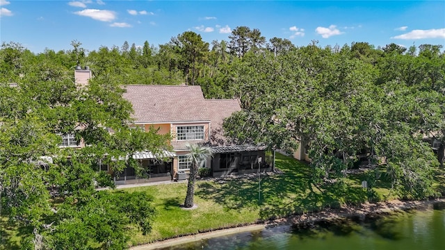 3611 Pine Knot Dr, Valrico, FL 33596 - rear view of property with a lawn, a chimney, a water view, and a sunroom