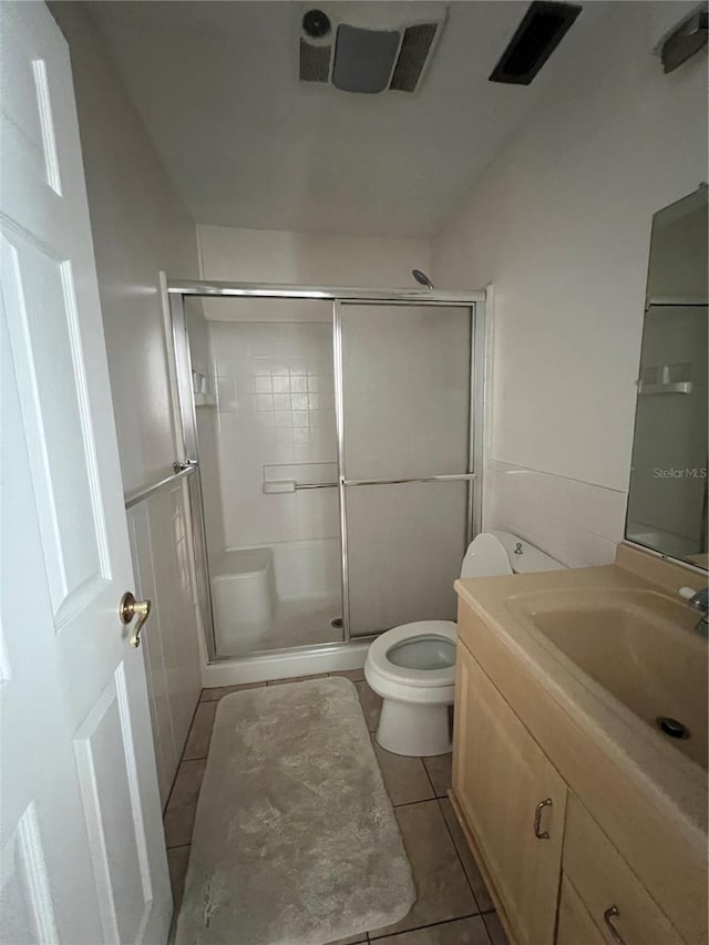 full bathroom featuring a shower stall, tile patterned floors, vanity, and toilet