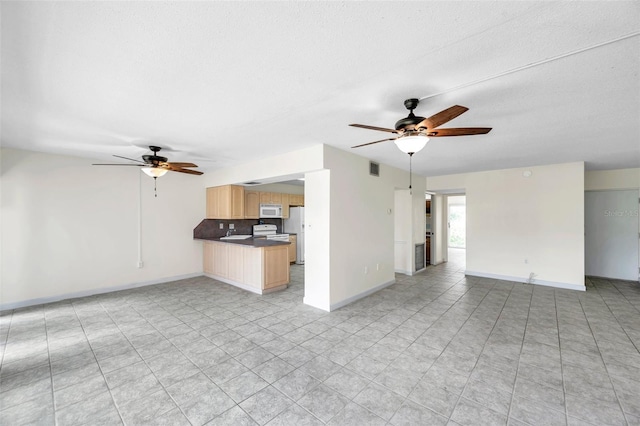 1655 S Highland Ave Unit D140, Clearwater, FL 33756 - unfurnished living room featuring a ceiling fan, baseboards, light tile patterned floors, and a textured ceiling