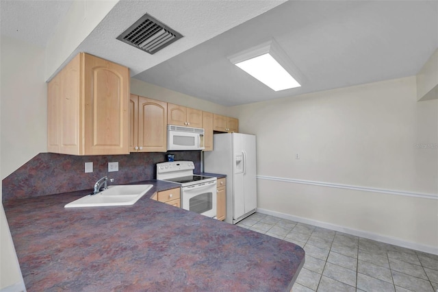 1655 S Highland Ave Unit D140, Clearwater, FL 33756 - kitchen with white appliances, light brown cabinetry, a sink, dark countertops, and light tile patterned floors
