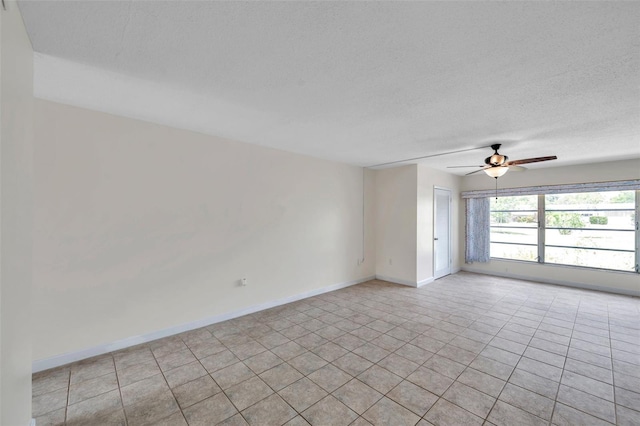 1655 S Highland Ave Unit D140, Clearwater, FL 33756 - empty room with ceiling fan, a textured ceiling, baseboards, and light tile patterned floors