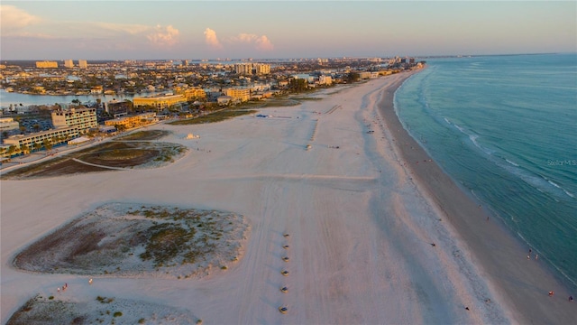 birds eye view of property featuring a city view, a view of the beach, and a water view